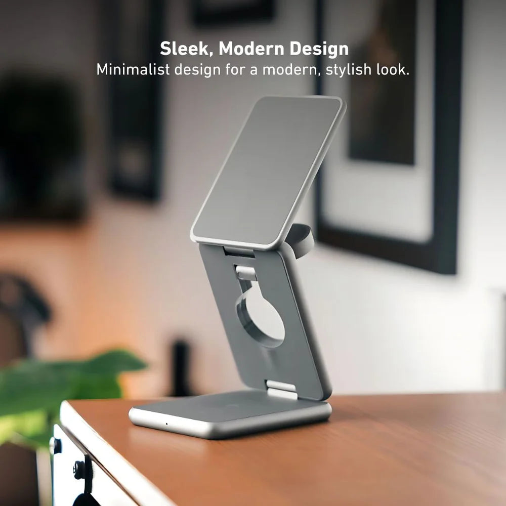 Silver phone stand on a desk with a blurred background