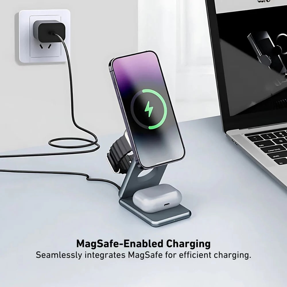 Phone on a stand charging with MagSafe technology, next to a laptop.