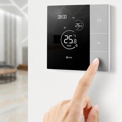 Digital ClimaClik Home Thermostat on a wall with a hand adjusting the settings