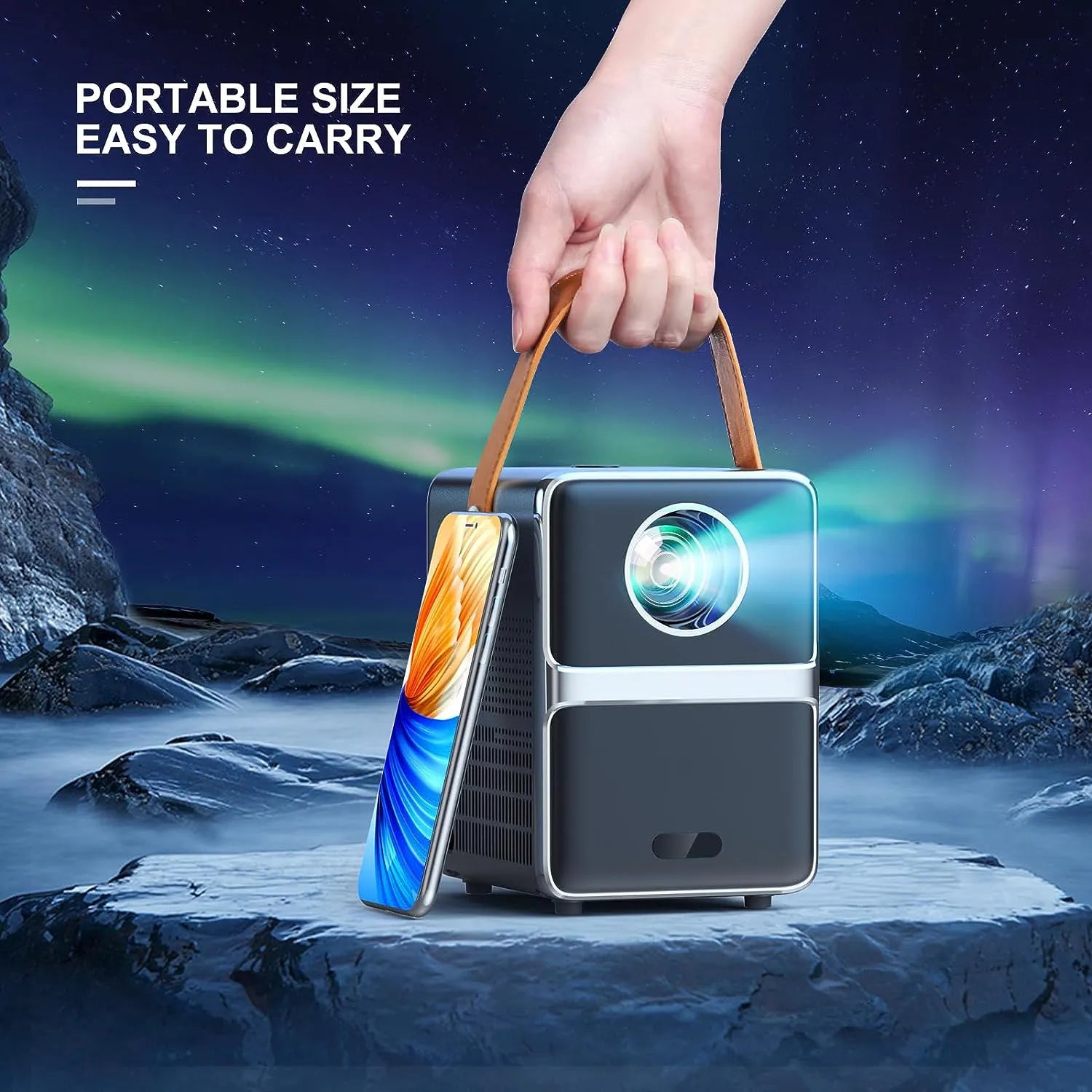Portable Lunorys Projector held by a hand with a snowy landscape and northern lights in the background