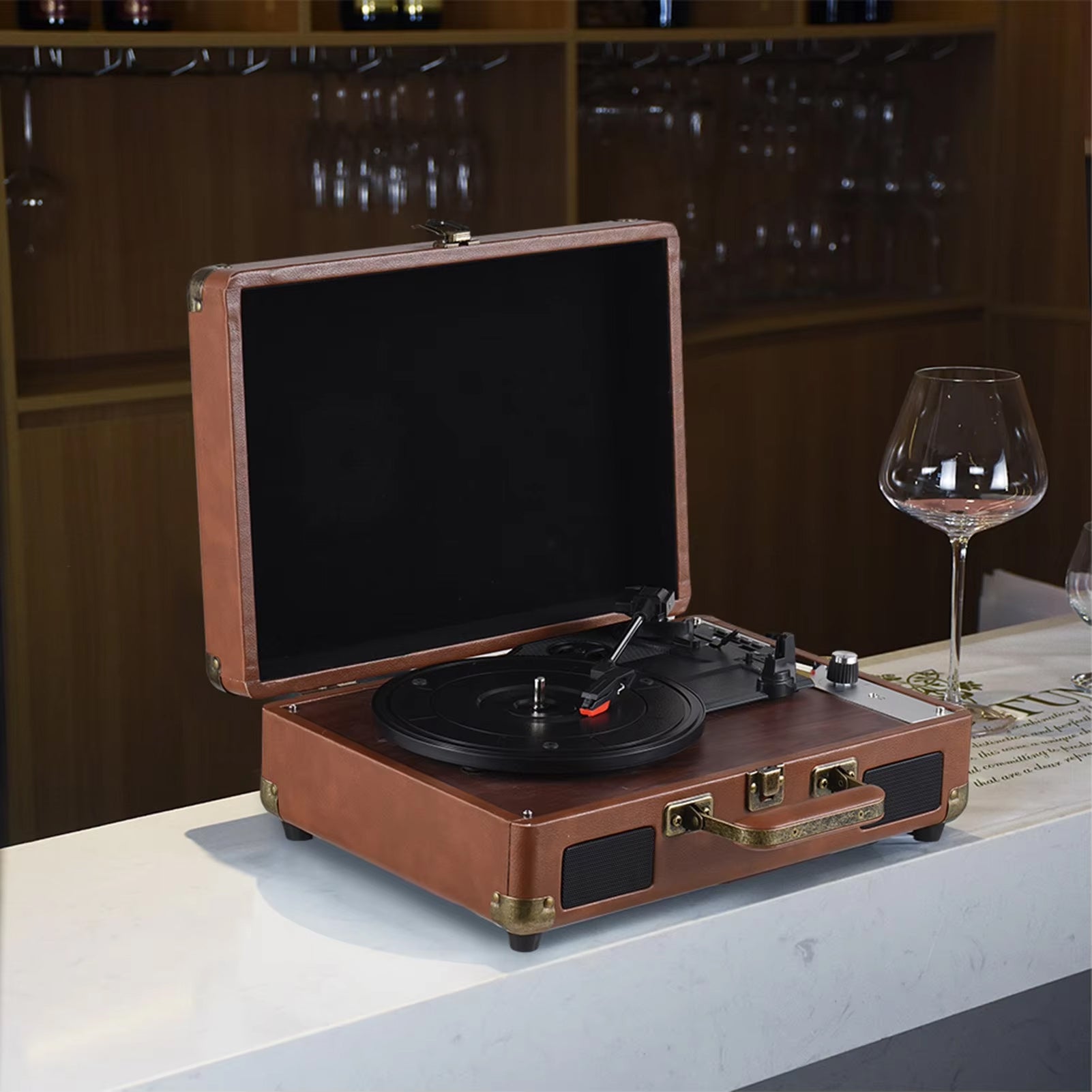 LyriHerz Suitcase Record Player next to glass 