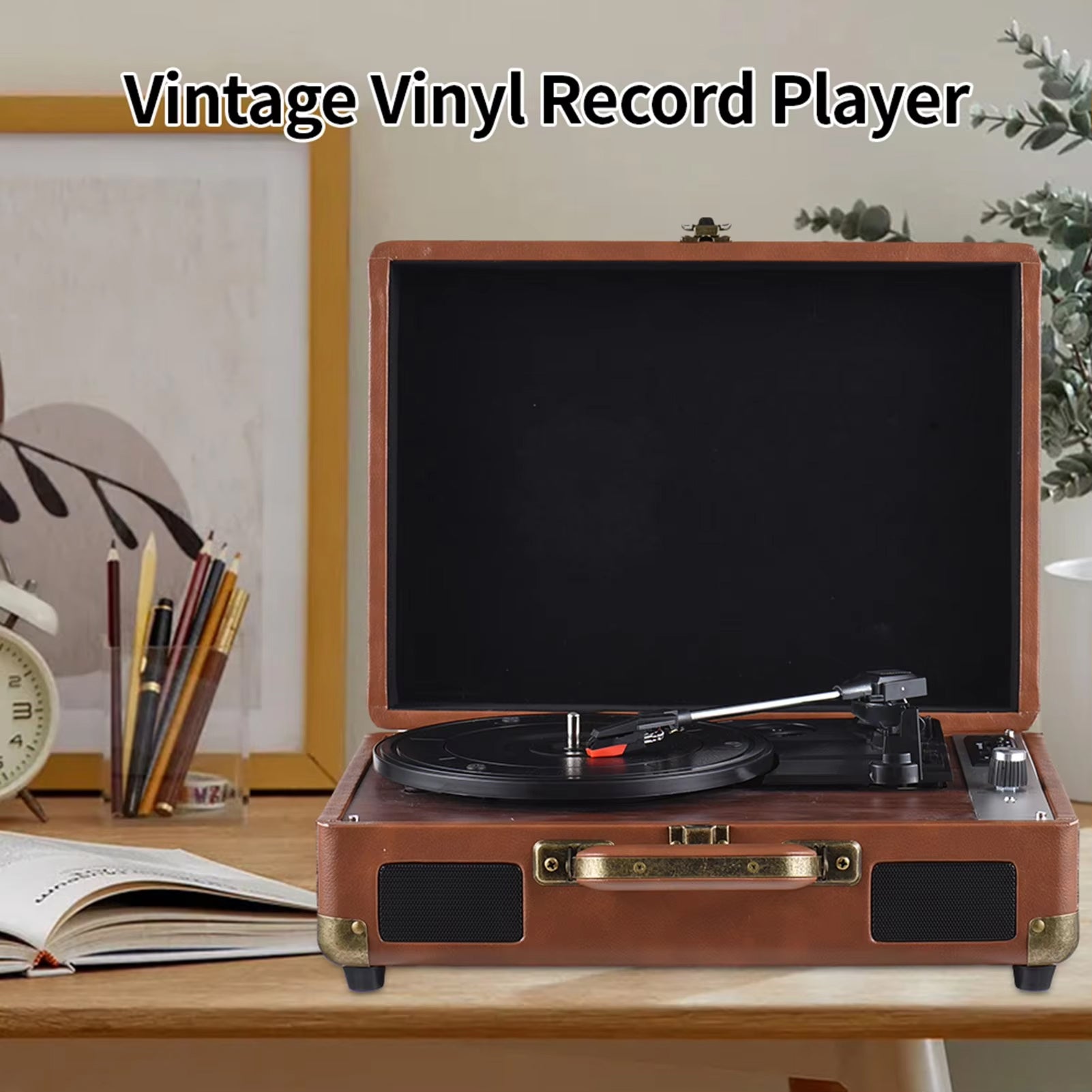 LyriHerz Suitcase Record Player on a wooden table with decor items in the background