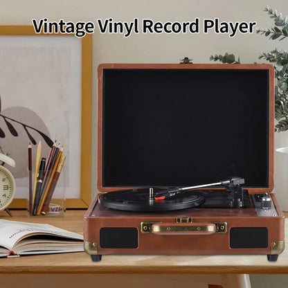 LyriHerz Suitcase Record Player on a wooden table with decor items in the background