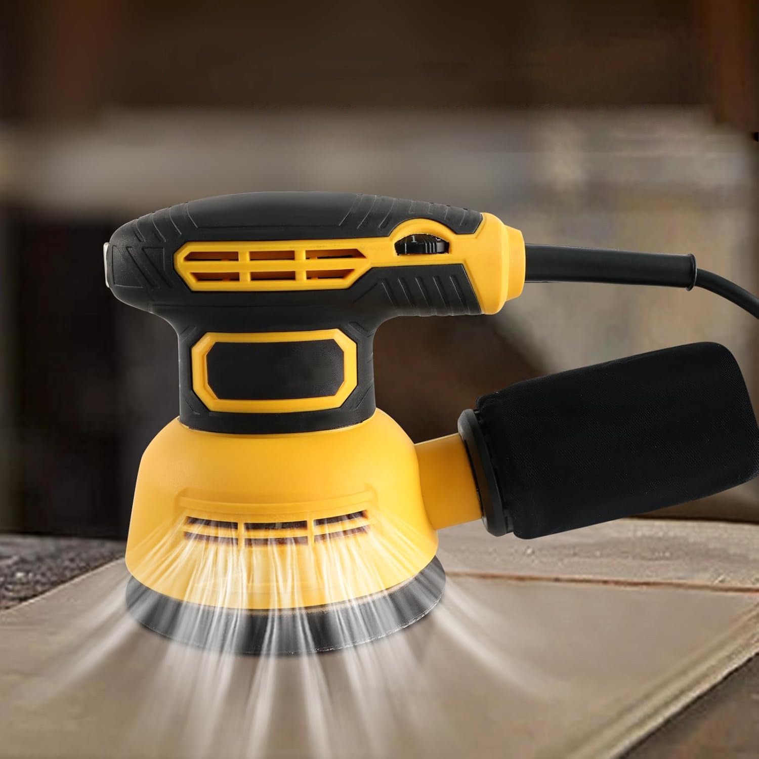 Yellow and black power Ocanvas Orbital Sander sanding a wooden surface with a blurred background
