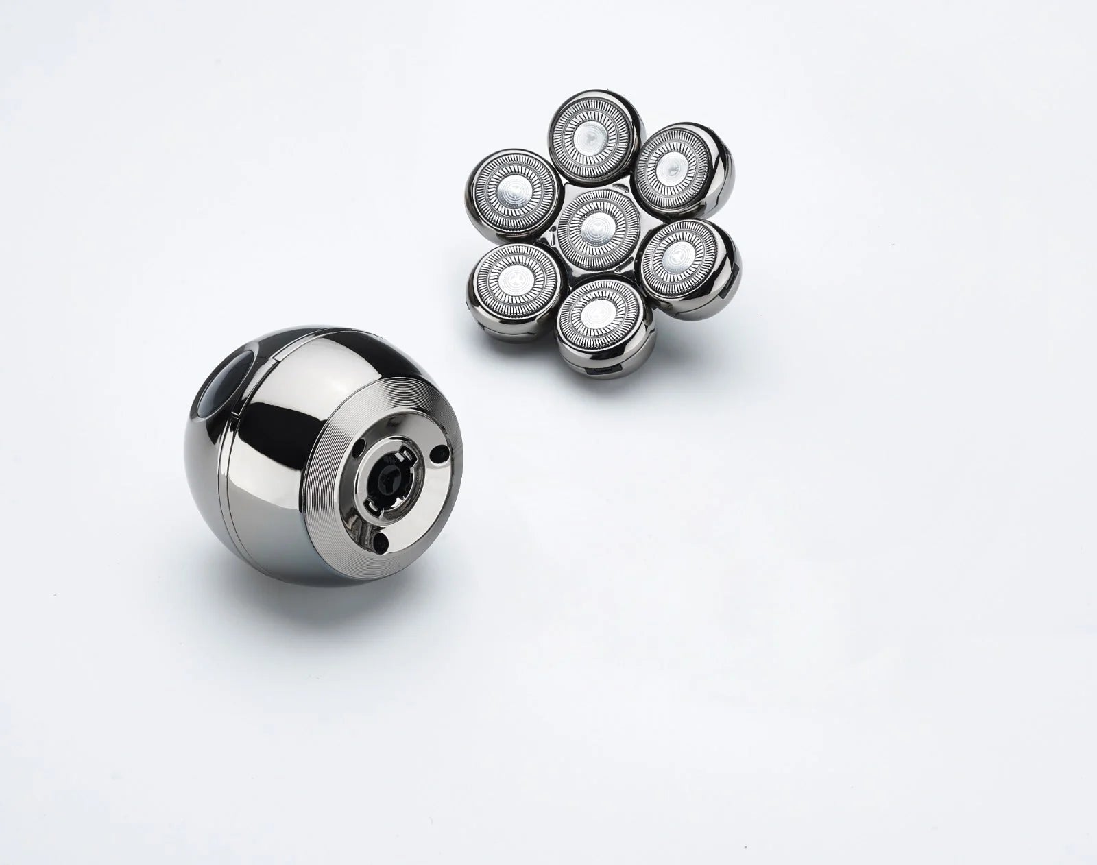 Metallic ball bearing and multiple smaller bearings on a white background
