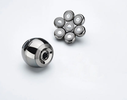 Metallic ball bearing and multiple smaller bearings on a white background
