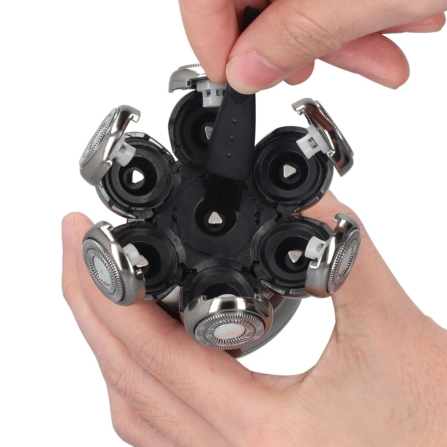 Multiple razor heads held together by a hand on a white background