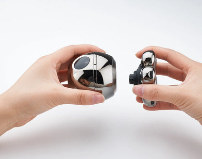 Two hands holding metallic cube-shaped objects against a white background