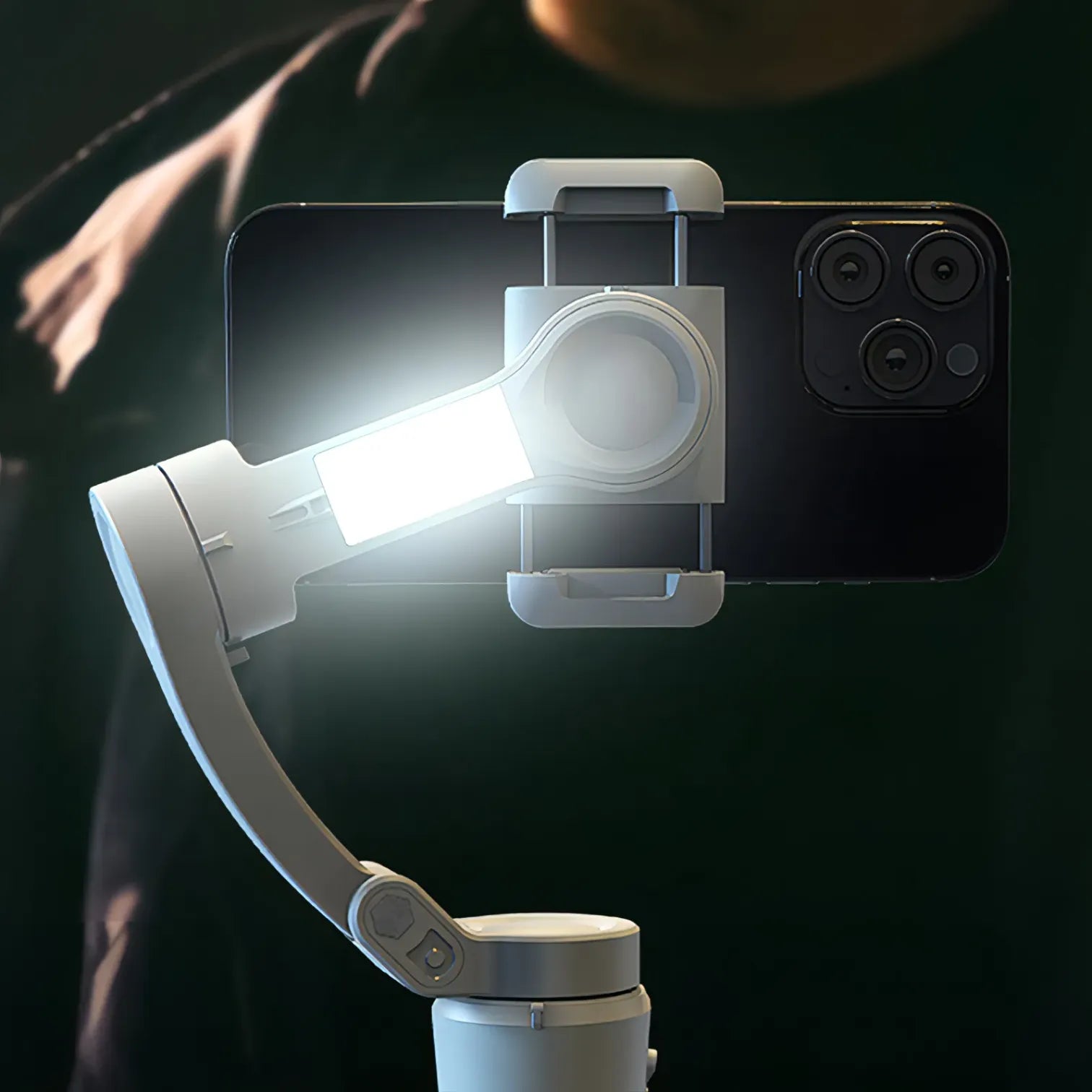 Smartphone with a mounted light and Puruxe Gimbal on a dark background