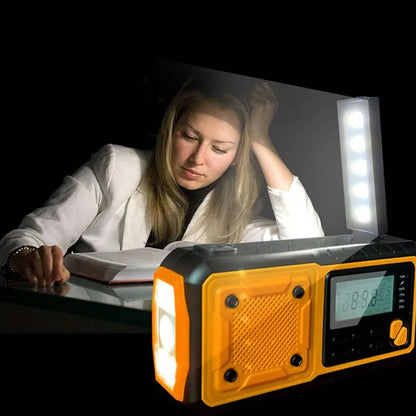 Person studying with a SafeNetto Emergency Radio flashlight on a dark background