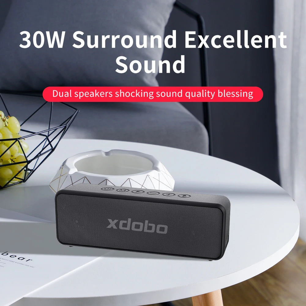 Black xdobo speaker on a white table with text about surround sound quality.