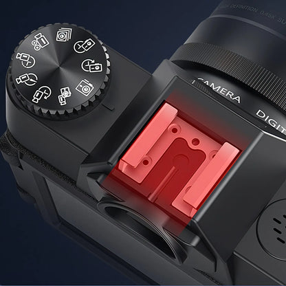 Camera body with a red flash attachment on a dark background