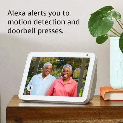 Smart display showing a video call with two people, with text about Alexa motion detection and doorbell alerts.