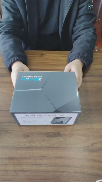 Unboxing the KINHANK X2 Pro Retro Gaming Console and connecting it to a monitor via HDMI, showing dual system boot into EmuELEC and Android TV
