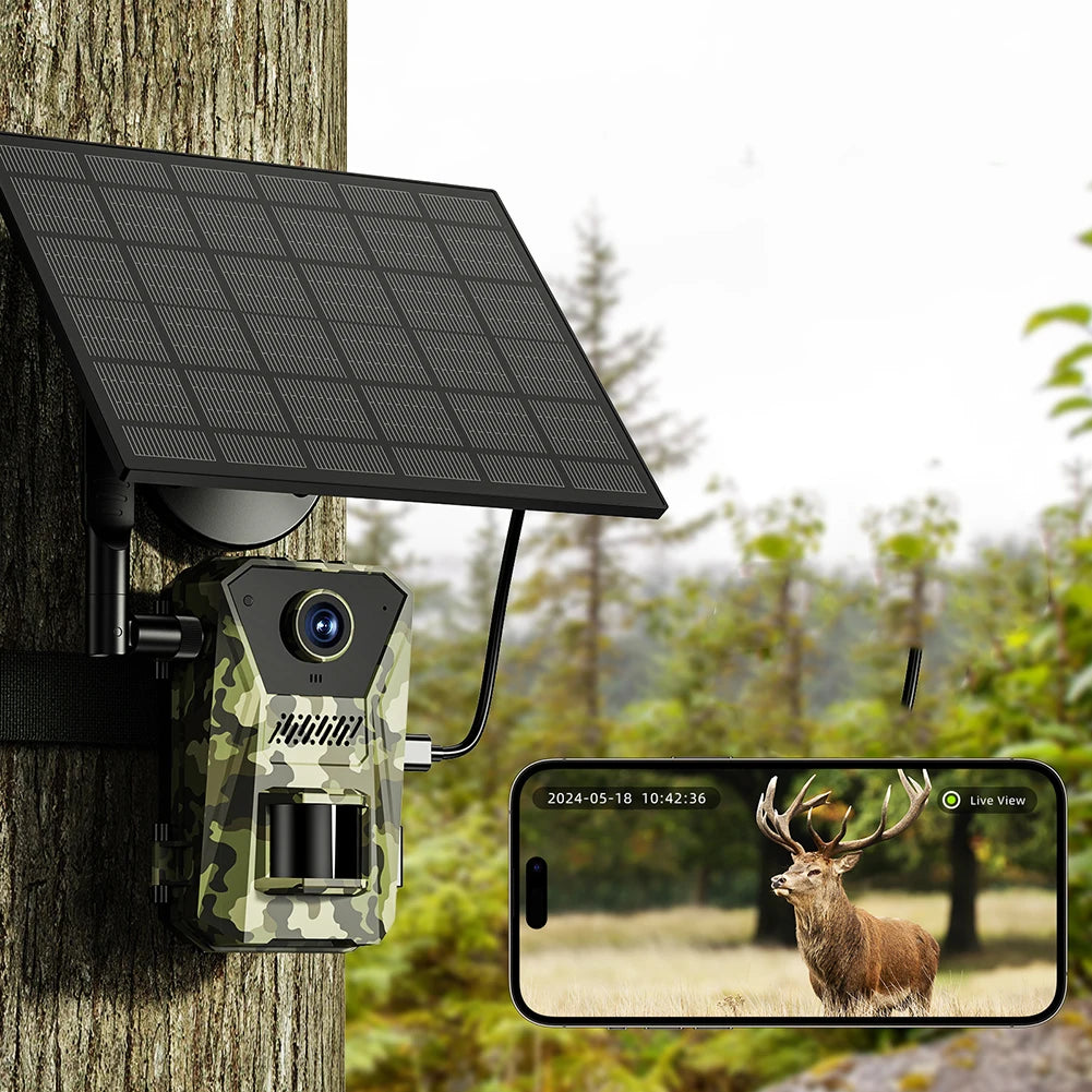 Solar-powered Trovoro Wildlife Camera attached to a tree with a smartphone displaying a deer image.