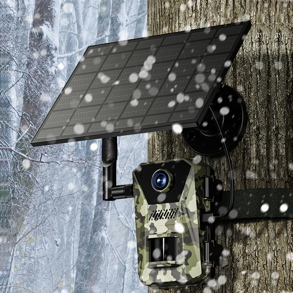 Trovoro Wildlife Camera with solar panel on a tree trunk in a snowy forest setting